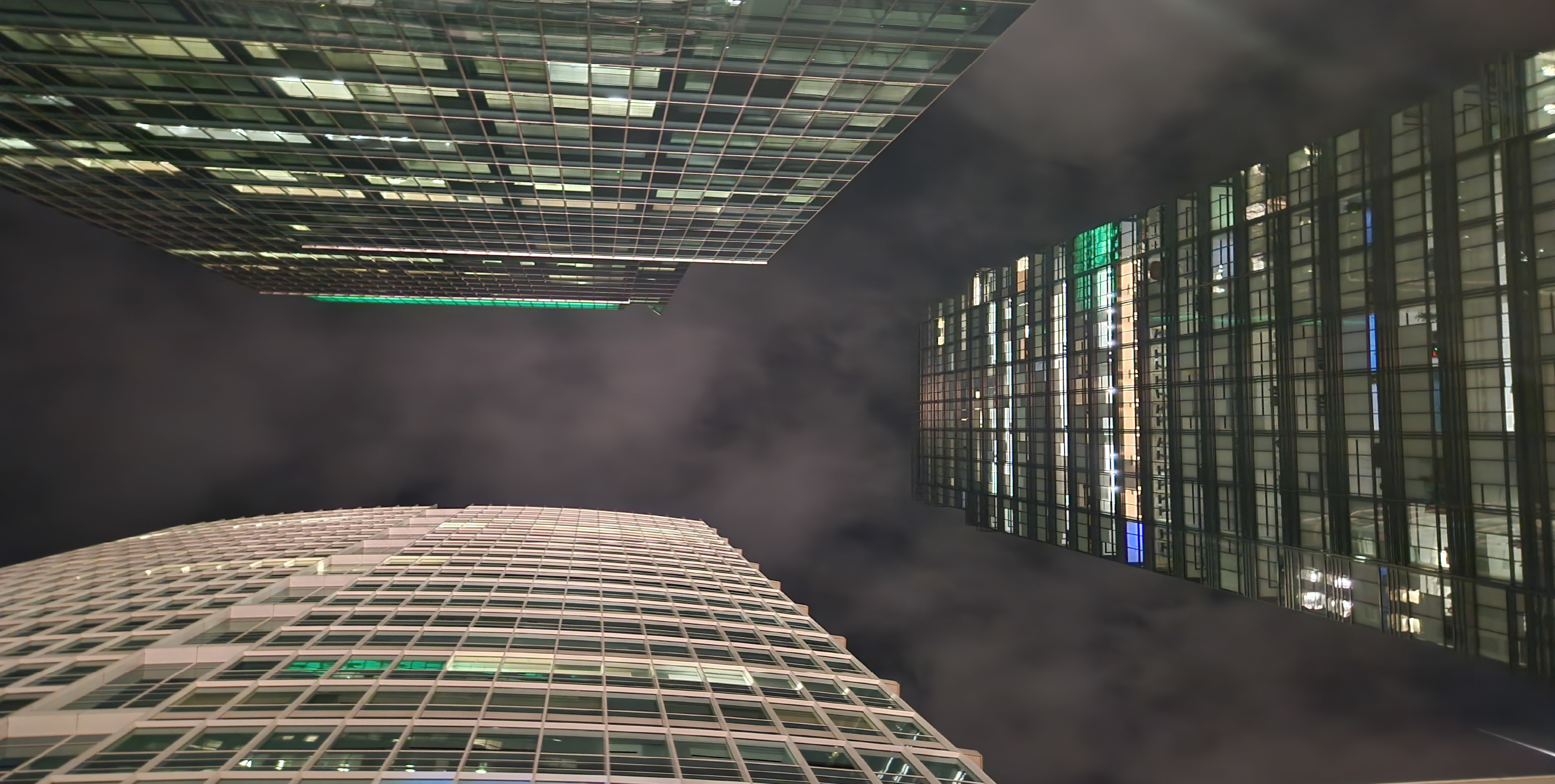 Image of the gray sky with three buildings in the view